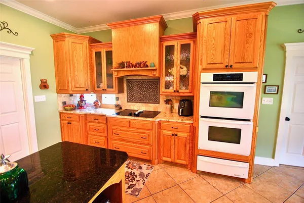 a large kitchen with stainless steel appliances granite countertop a stove a sink and a refrigerator
