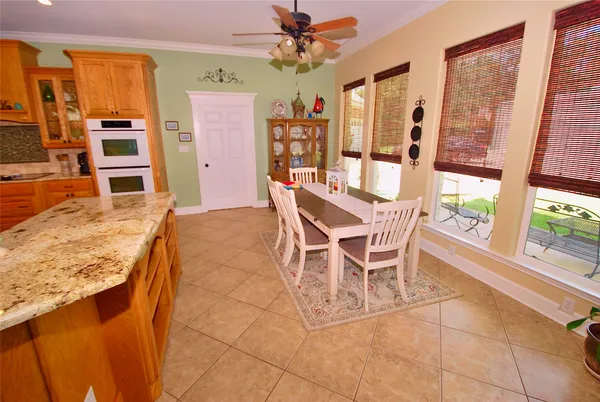 a dining room with furniture and large windows