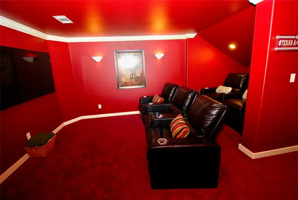 a living room with furniture and a book shelf