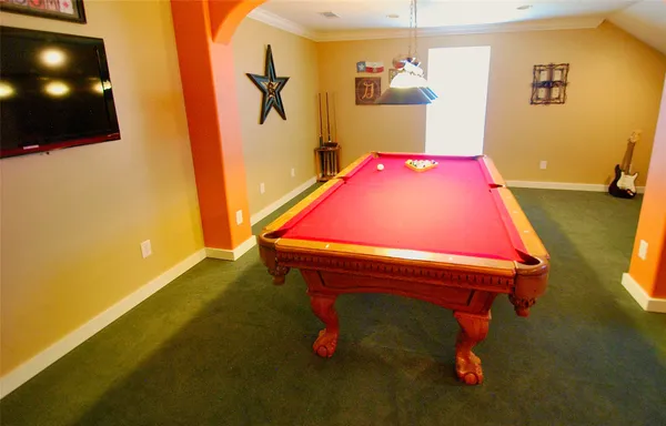 a room with stainless steel appliances furniture and a wooden floor
