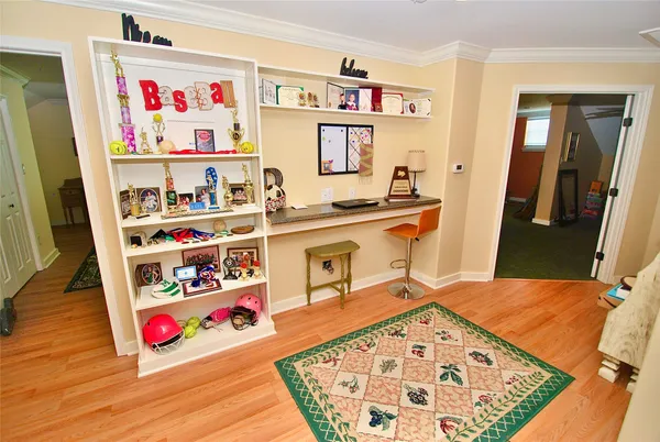 a living room with couches and a dining table with wooden floor