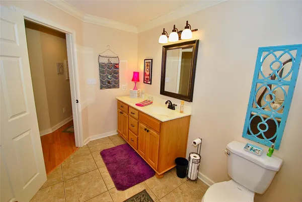 a bathroom with a sink a toilet and mirror