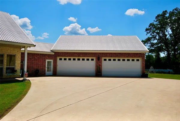 a front view of a building with a yard and garage