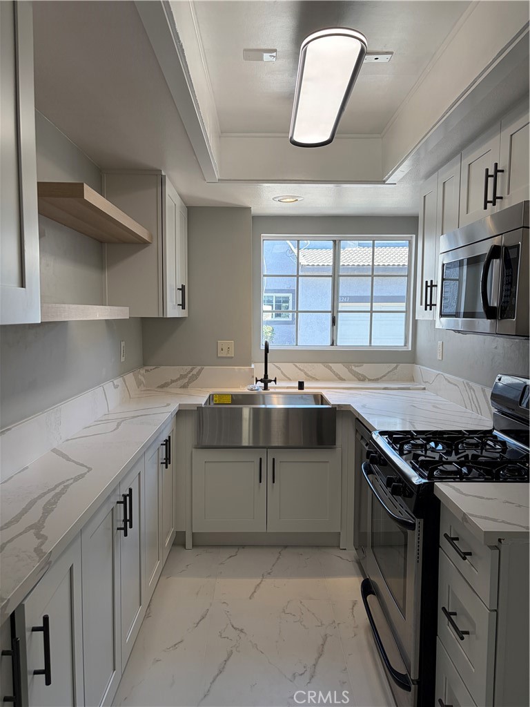8248 Inglenook Place Rancho Cucamonga, CA 91730 - Photo 1 of 12 a kitchen with stainless steel appliances granite countertop a sink a stove and a wooden floors