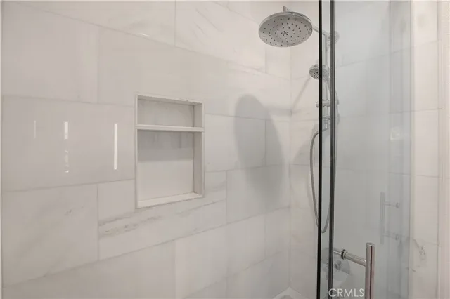 a bathroom with a glass shower door