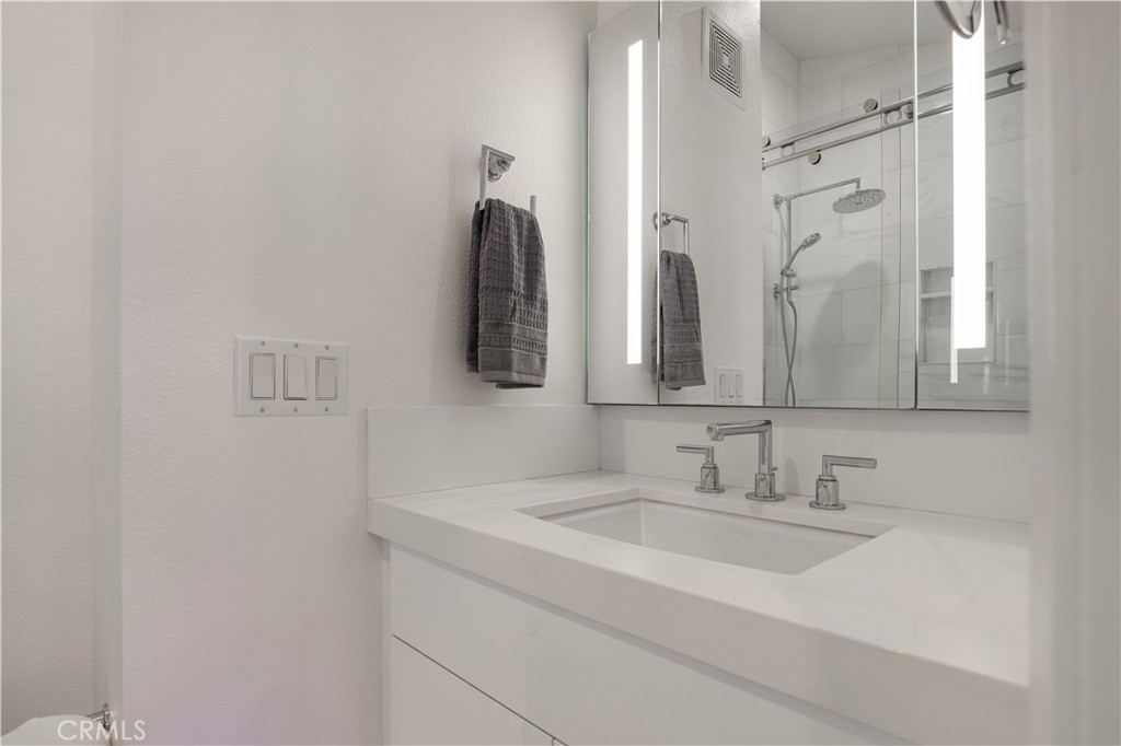 30902 Club House Drive, Unit 11J Laguna Niguel, CA 92677 - Photo 18 of 32 a bathroom with a sink and a mirror