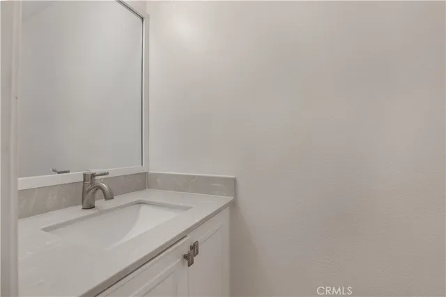 a bathroom with a sink and vanity