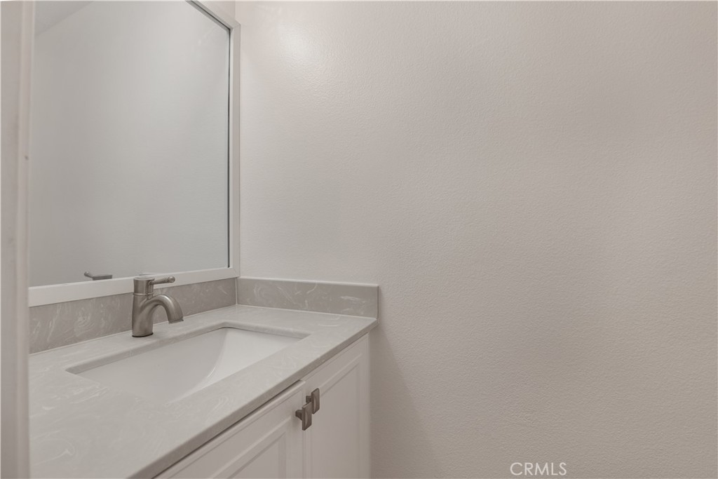 30902 Club House Drive, Unit 11J Laguna Niguel, CA 92677 - Photo 25 of 32 a bathroom with a sink and vanity