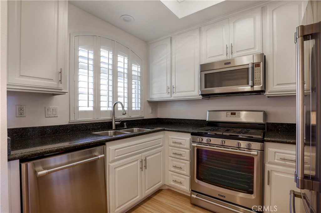 30902 Club House Drive, Unit 11J Laguna Niguel, CA 92677 - Photo 27 of 32 a kitchen with granite countertop cabinets stainless steel appliances a sink and window