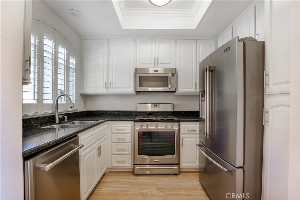 30902 Club House Drive, Unit 11J Laguna Niguel, CA 92677 - Photo 28 of 32 a kitchen with a stove microwave and refrigerator
