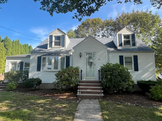 a front view of a house with a garden
