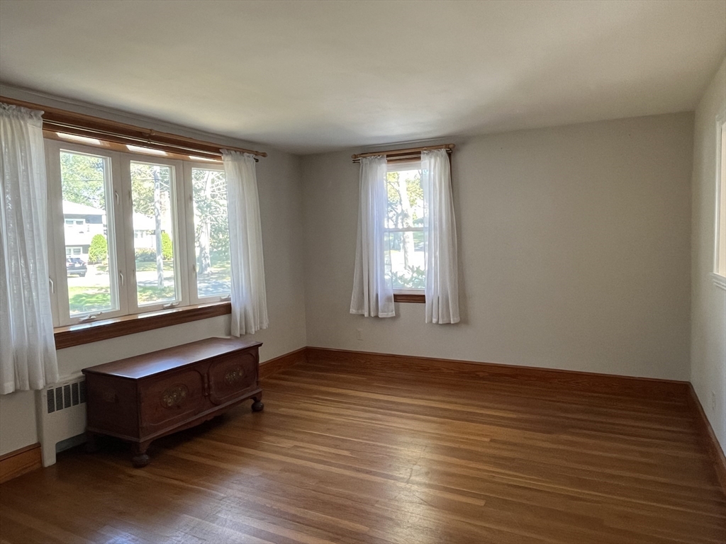 48 Ashton Street Beverly, MA 01915 - Photo 11 of 24 a view of an empty room with wooden floor and a window