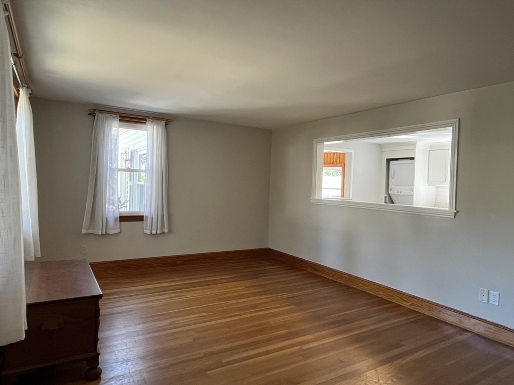 48 Ashton Street Beverly, MA 01915 - Photo 12 of 24 a view of an empty room with wooden floor and a window