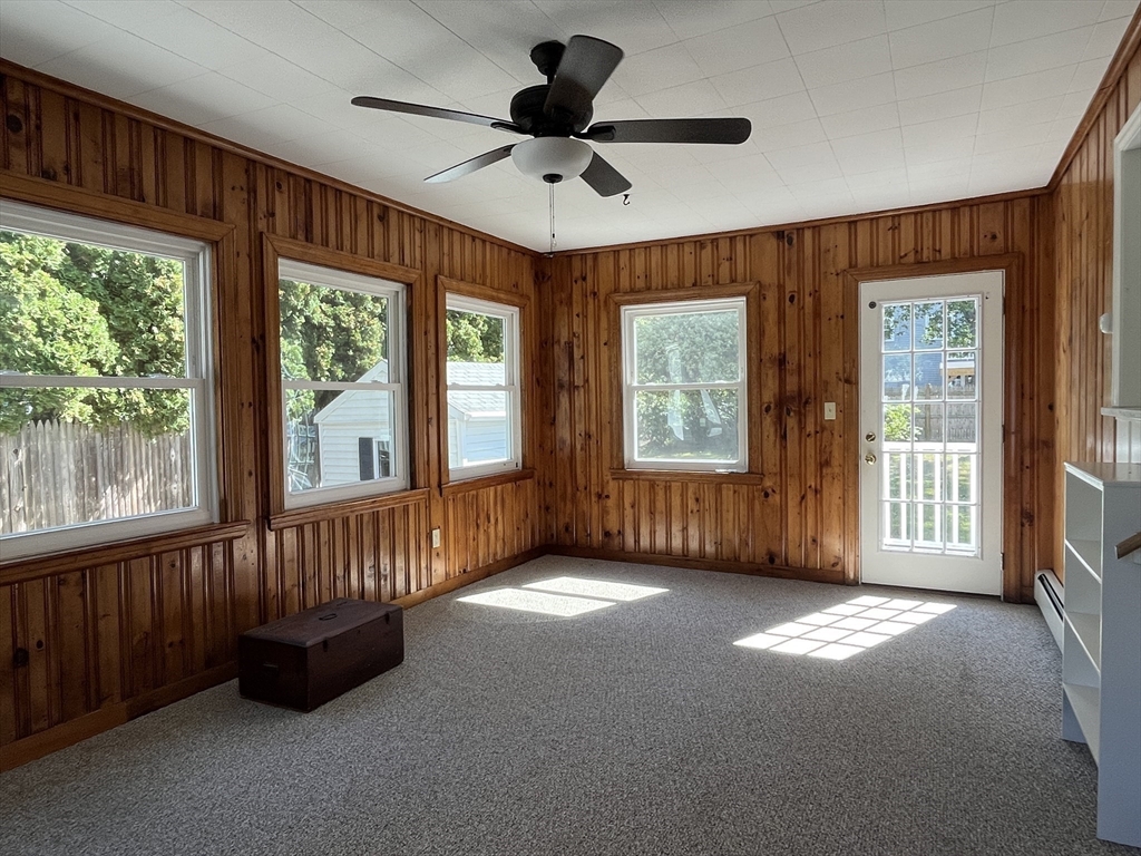 48 Ashton Street Beverly, MA 01915 - Photo 14 of 24 a view of an empty room with windows & cabinet