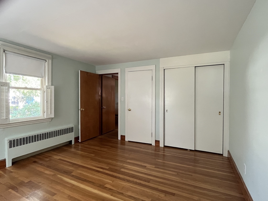 48 Ashton Street Beverly, MA 01915 - Photo 15 of 24 a view of an empty room with wooden floor and a window
