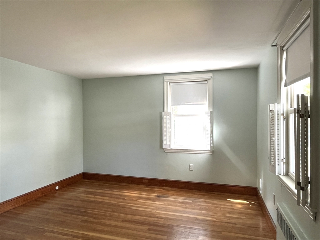 48 Ashton Street Beverly, MA 01915 - Photo 16 of 24 an empty room with wooden floor and a window