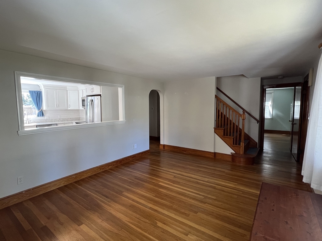 48 Ashton Street Beverly, MA 01915 - Photo 10 of 24 a view of an empty room with wooden floor and a window