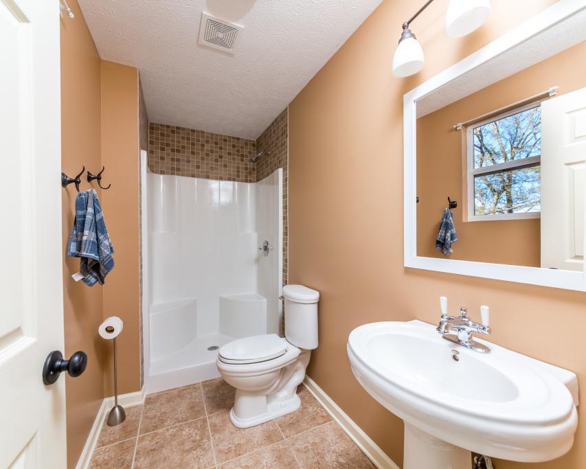 323 Mayhew Road Clarksville, TN 37040 - Photo 11 of 30 a bathroom with a toilet sink and mirror