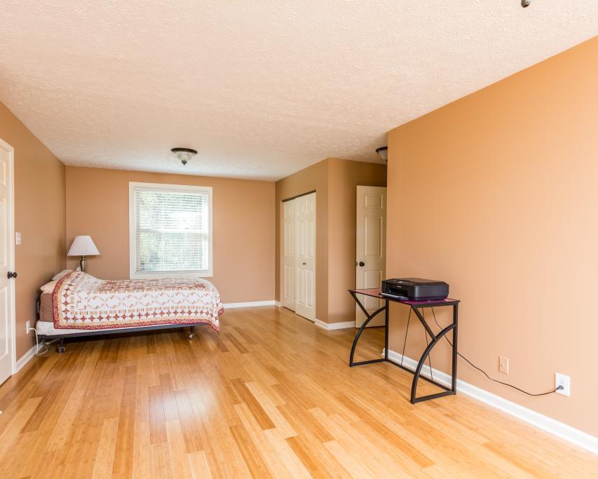 323 Mayhew Road Clarksville, TN 37040 - Photo 19 of 30 a bedroom with a bed and wooden floor