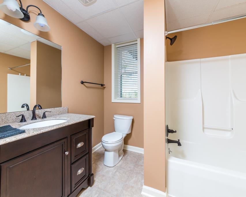 323 Mayhew Road Clarksville, TN 37040 - Photo 25 of 30 a bathroom with a granite countertop sink toilet a mirror and bathtub