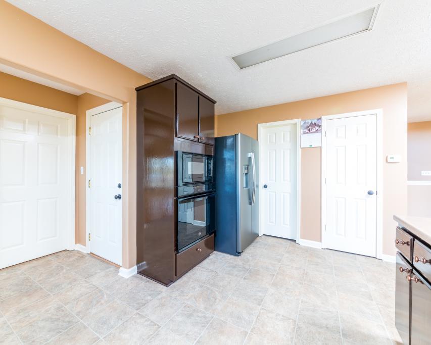 323 Mayhew Road Clarksville, TN 37040 - Photo 7 of 30 a view of kitchen with refrigerator cabinets and wooden floor