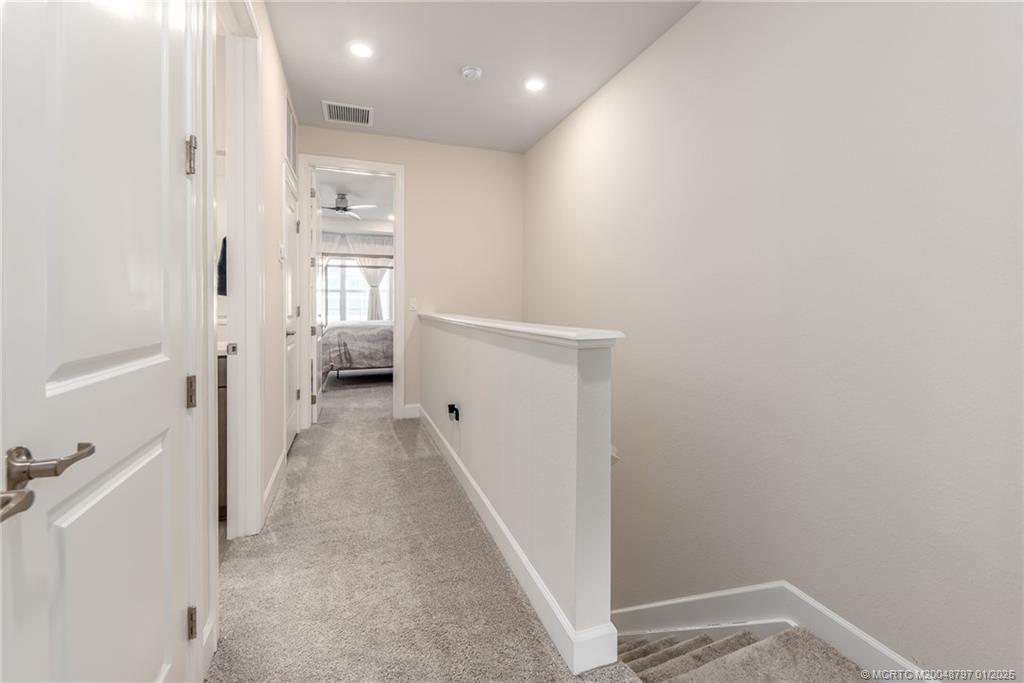 1865 Southeast Tarni Way Stuart, FL 34996 - Photo 18 of 23 a view of a hallway with white walls