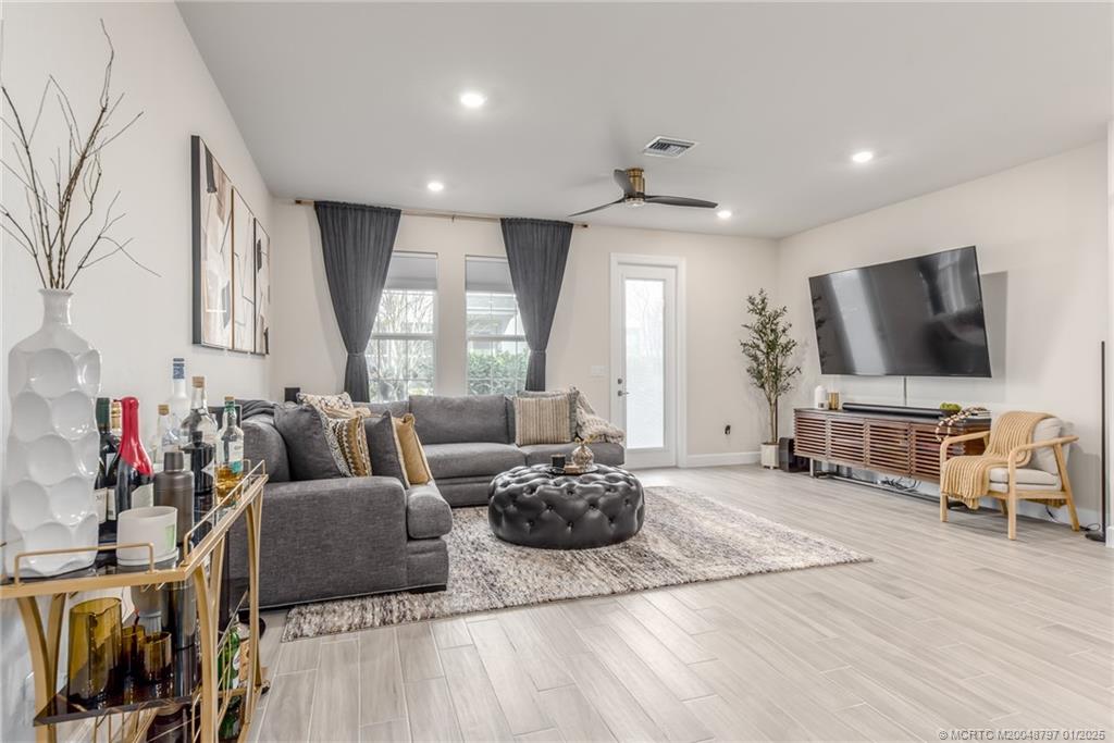 1865 Southeast Tarni Way Stuart, FL 34996 - Photo 8 of 23 a living room with furniture and a flat screen tv