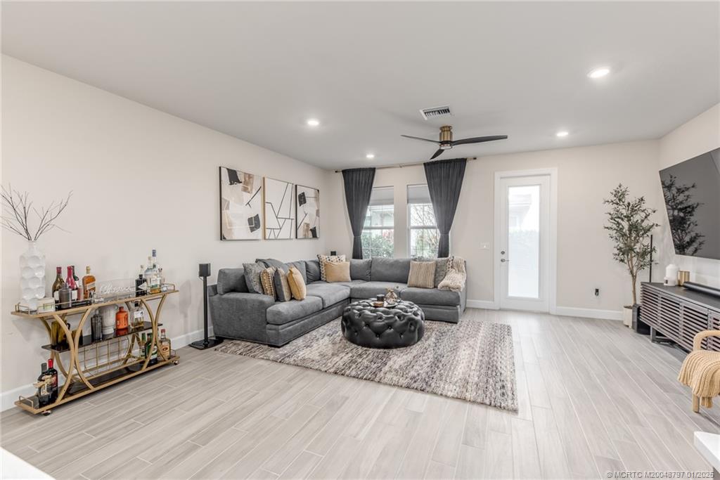 1865 Southeast Tarni Way Stuart, FL 34996 - Photo 9 of 23 a living room with furniture and a flat screen tv