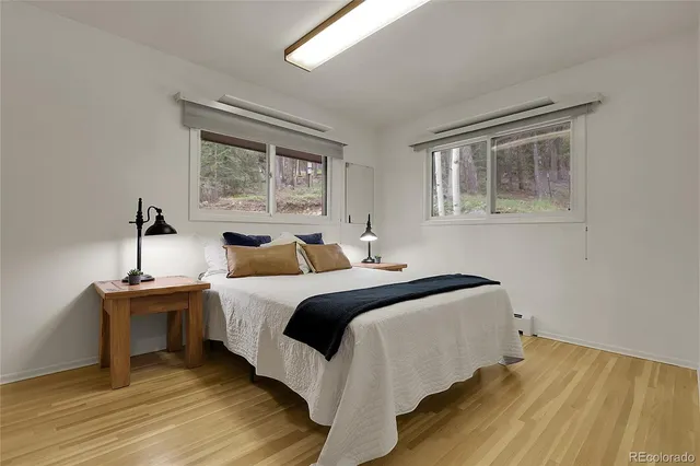 a bedroom with a bed and a night stand