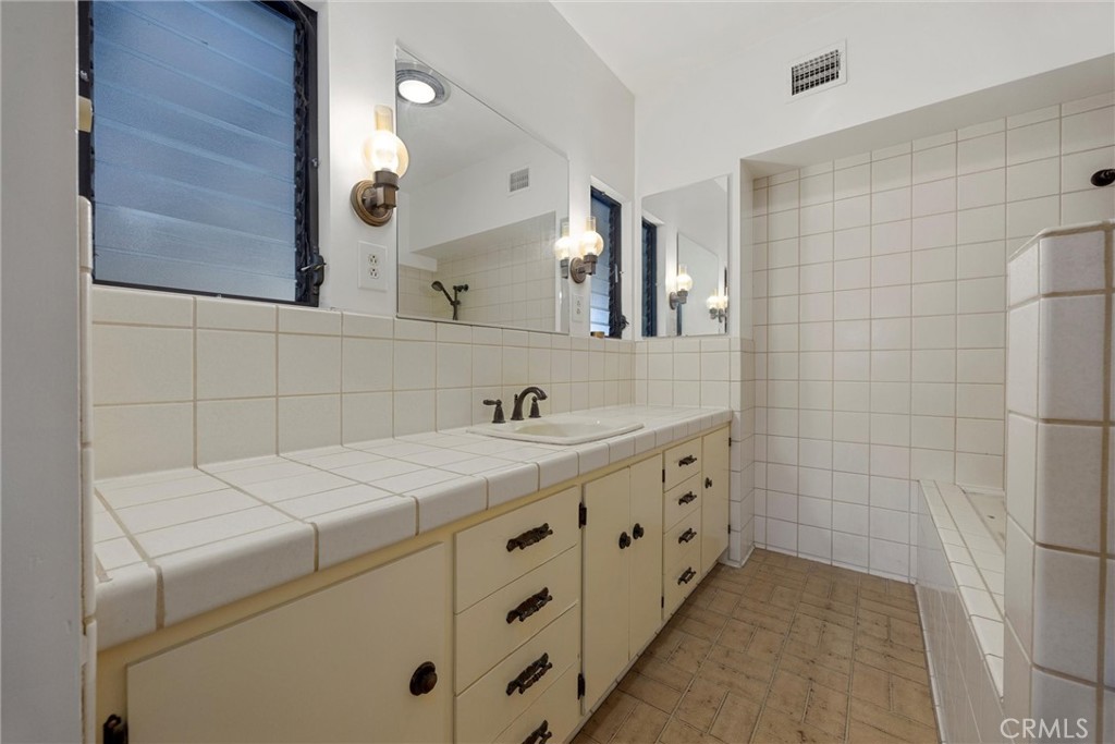 240 South Real Road Bakersfield, CA 93309 - Photo 17 of 35 a bathroom with a sink a vanity and a mirror