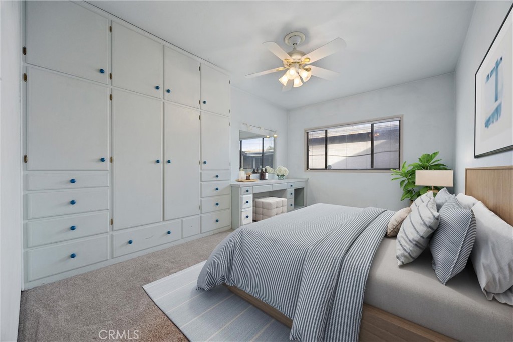 240 South Real Road Bakersfield, CA 93309 - Photo 19 of 35 a spacious bedroom with a bed and a chandelier