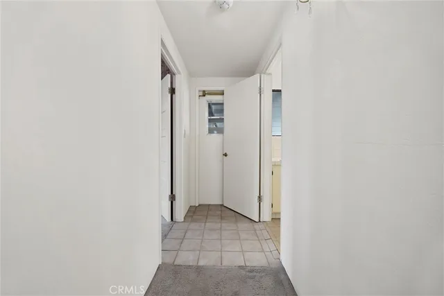 a spacious bedroom with a bed and a chandelier