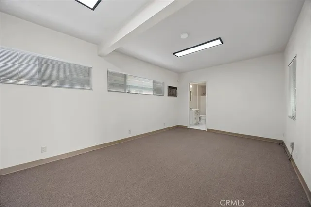 a view of empty room with refrigerator