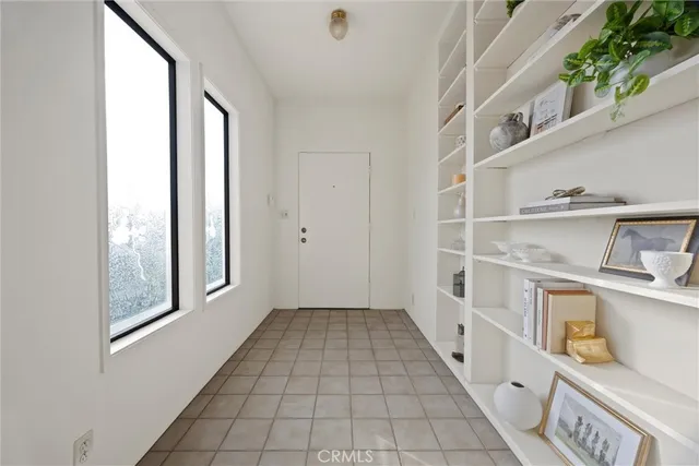 a dining room with furniture and a potted plant