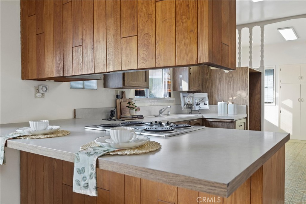 240 South Real Road Bakersfield, CA 93309 - Photo 10 of 35 a kitchen with kitchen island granite countertop a sink a stove and a cabinets