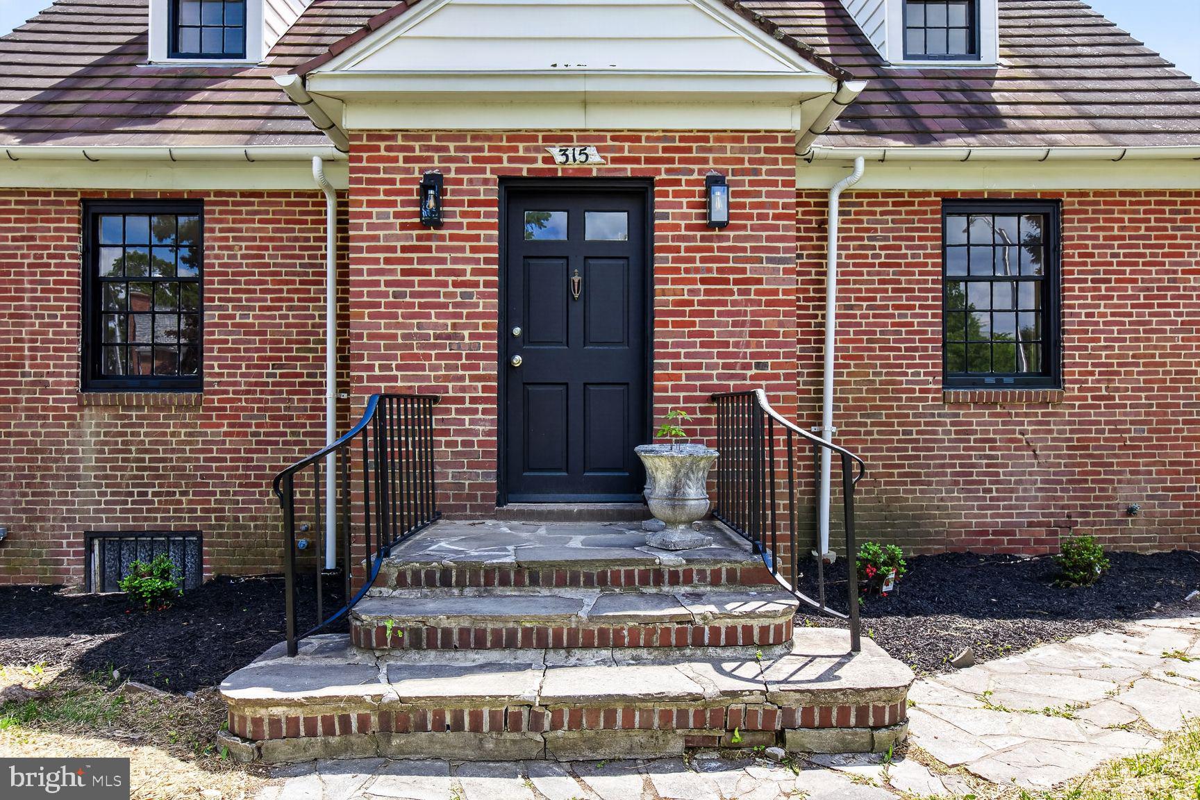 315 East Cold Spring Lane Baltimore, MD 21212 - Photo 12 of 25 a front view of a house with a garden