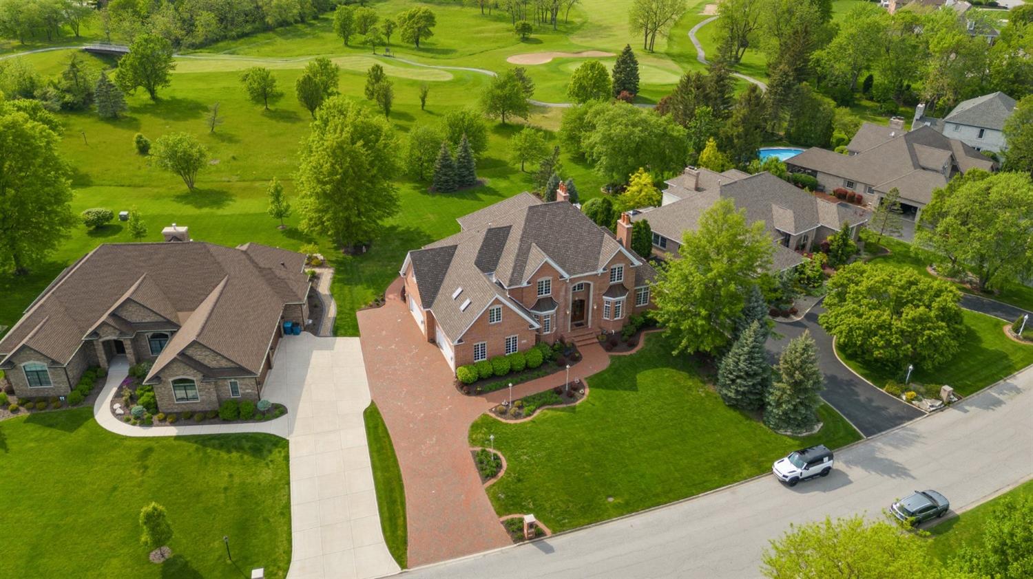 an aerial view of a house with garden space and street view