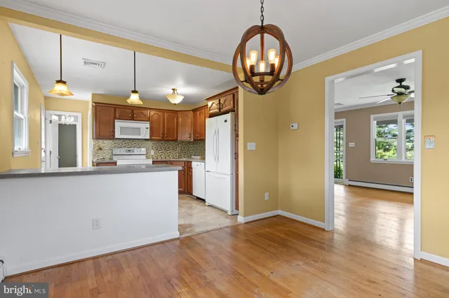 a kitchen with granite countertop a refrigerator and a stove top oven