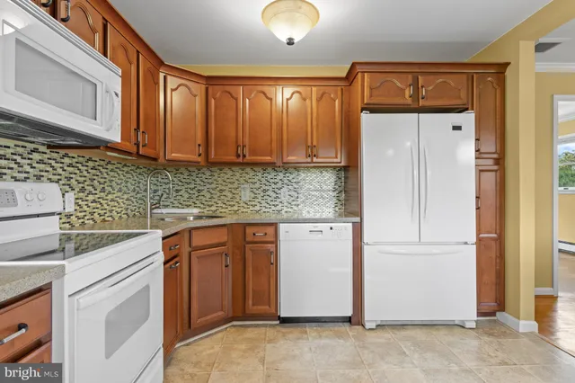 a kitchen with a refrigerator a sink and dishwasher