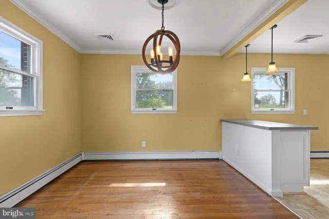 a view of room with window and wooden floor