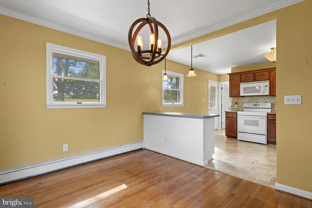 a view of kitchen with cabinets and wooden floor