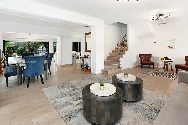a living room with furniture a rug and a fireplace