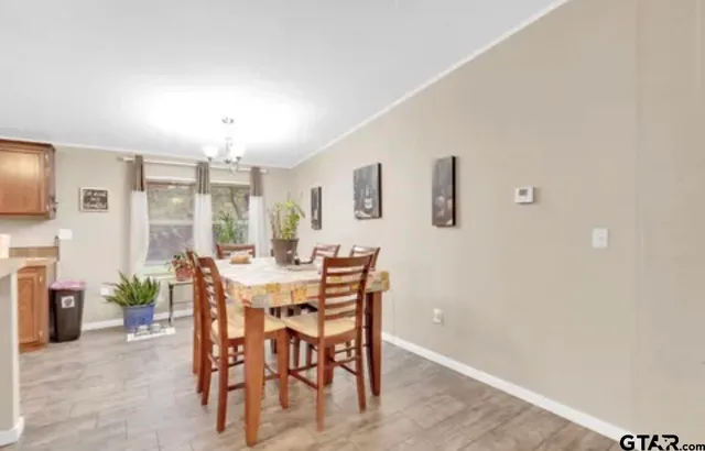 a view of a dining room with furniture and chandelier