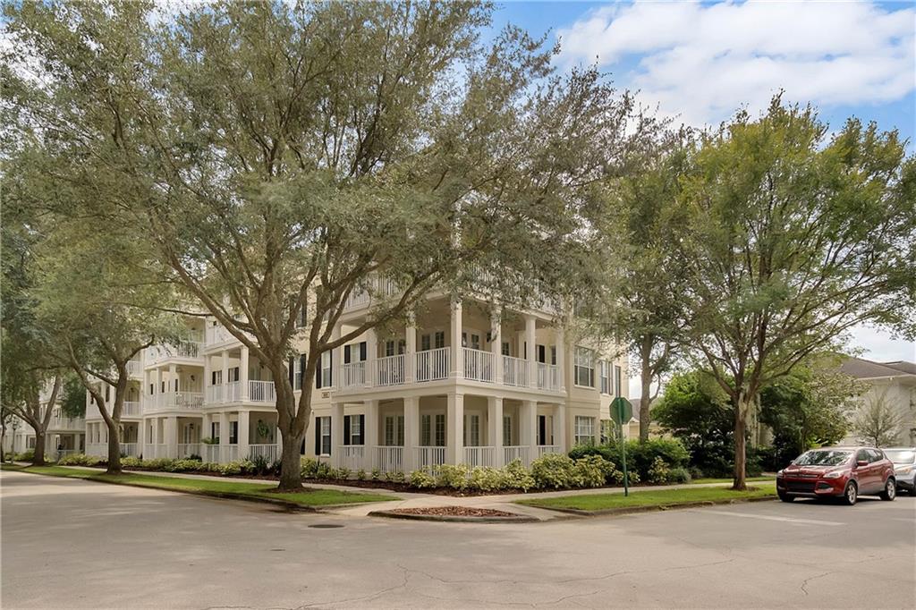900 Spring Park Street, Unit 101 Celebration, FL 34747 - Photo 1 of 1 a city street lined with buildings and trees