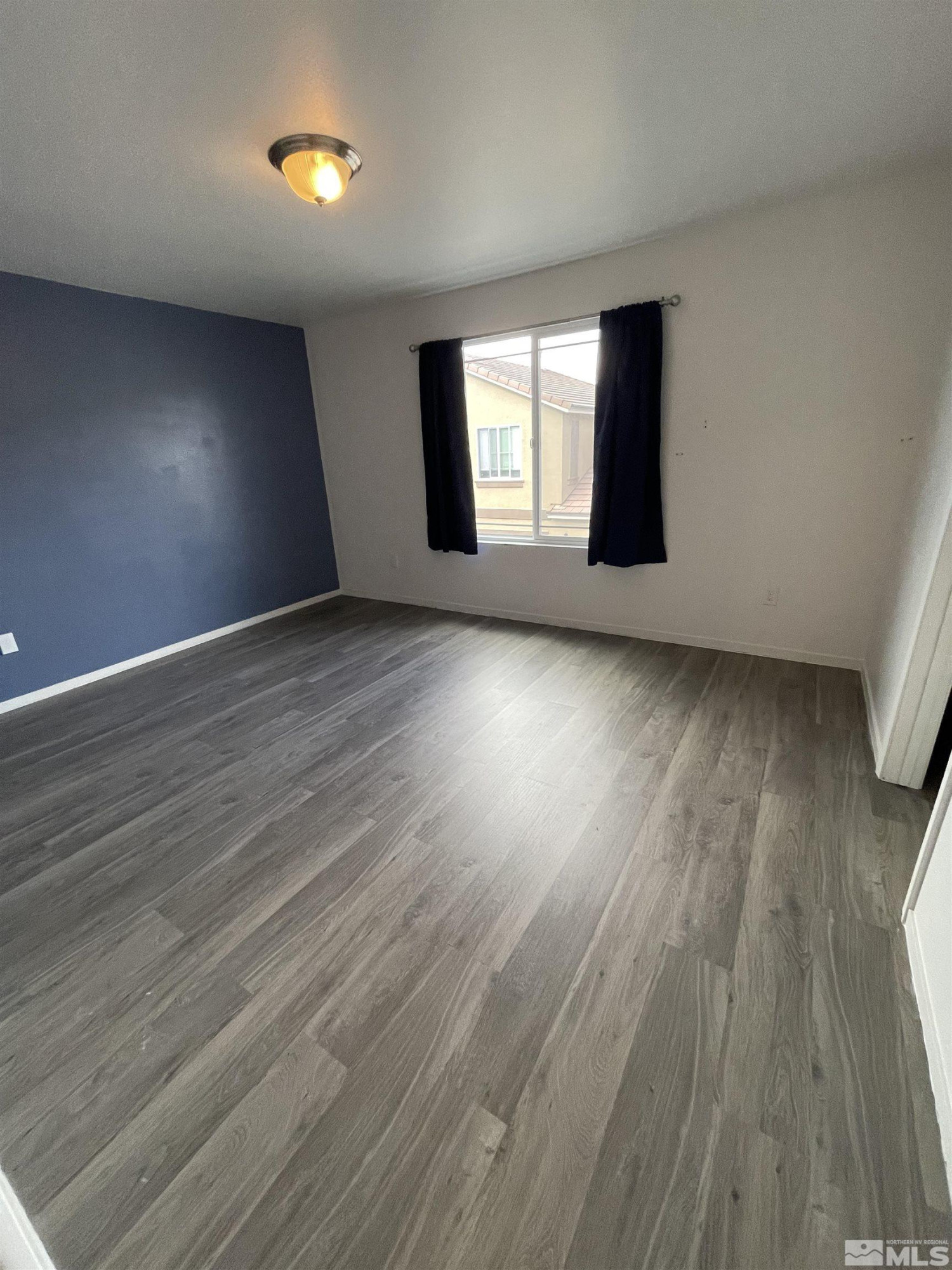 9622 Windjammer Way Reno, NV 89506 - Photo 13 of 15 an empty room with wooden floor and windows