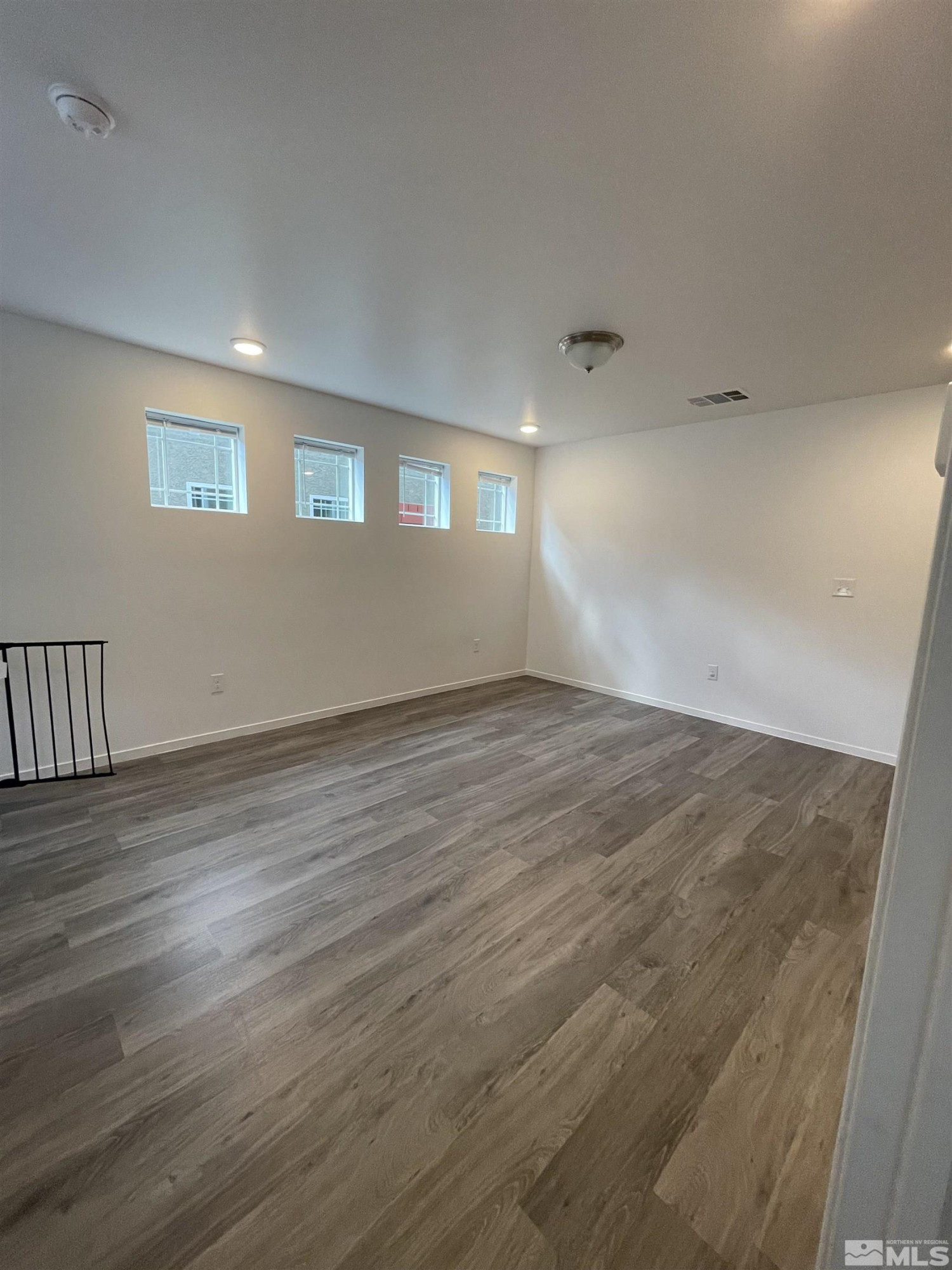 9622 Windjammer Way Reno, NV 89506 - Photo 6 of 15 a view of an empty room with wooden floor and a window