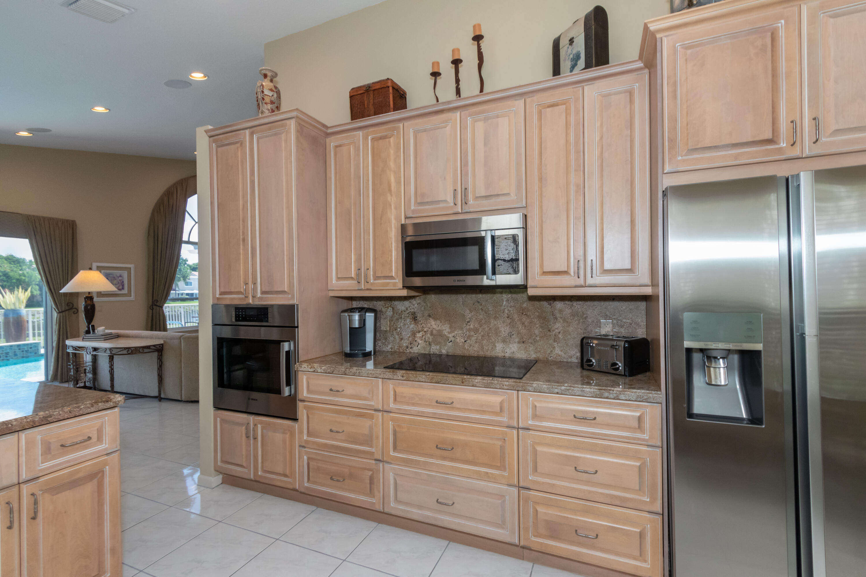 23402 Torre Circle Boca Raton, FL 33433 - Photo 13 of 44 a kitchen with granite countertop white cabinets and stainless steel appliances