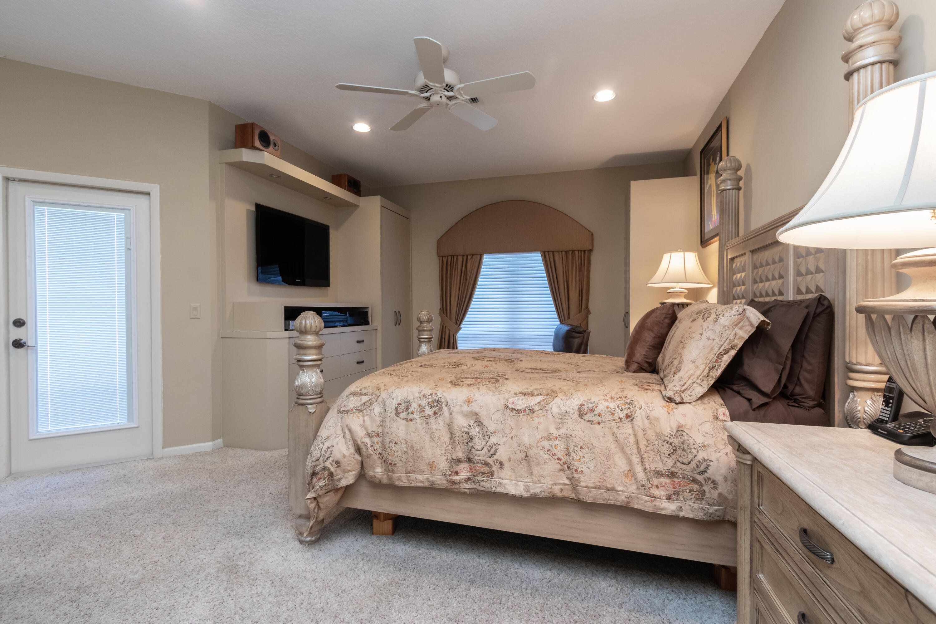 23402 Torre Circle Boca Raton, FL 33433 - Photo 17 of 44 a bedroom with a large bed and a flat tv screen on dresser