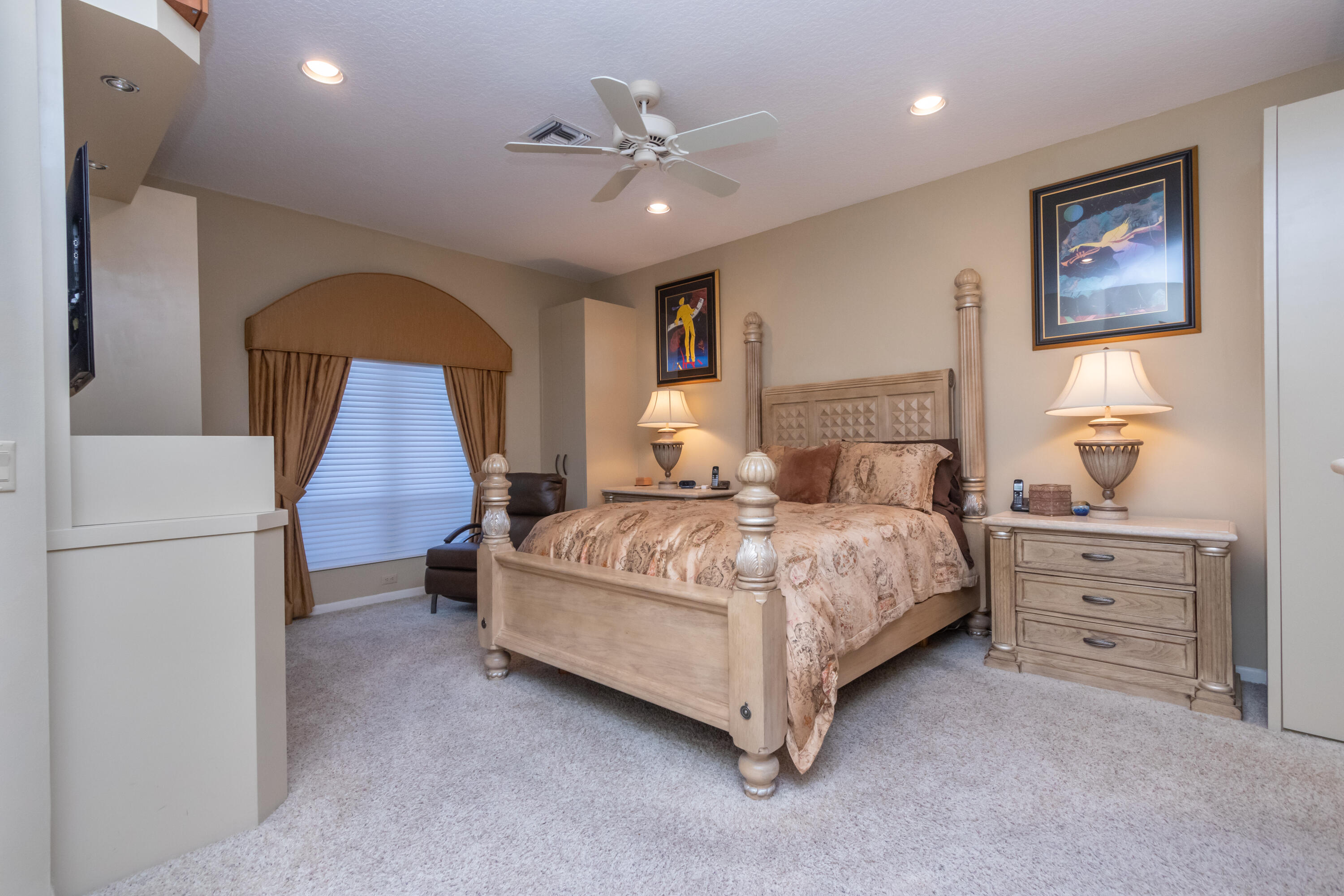 23402 Torre Circle Boca Raton, FL 33433 - Photo 18 of 44 a bedroom with a large bed and a chandelier