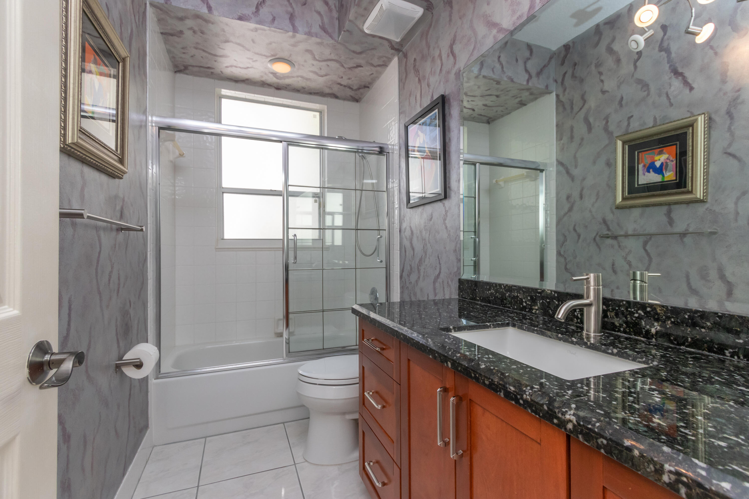 23402 Torre Circle Boca Raton, FL 33433 - Photo 29 of 44 a bathroom with a granite countertop sink toilet and shower